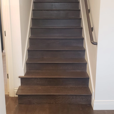 black wooden stairs with metal rail adger al